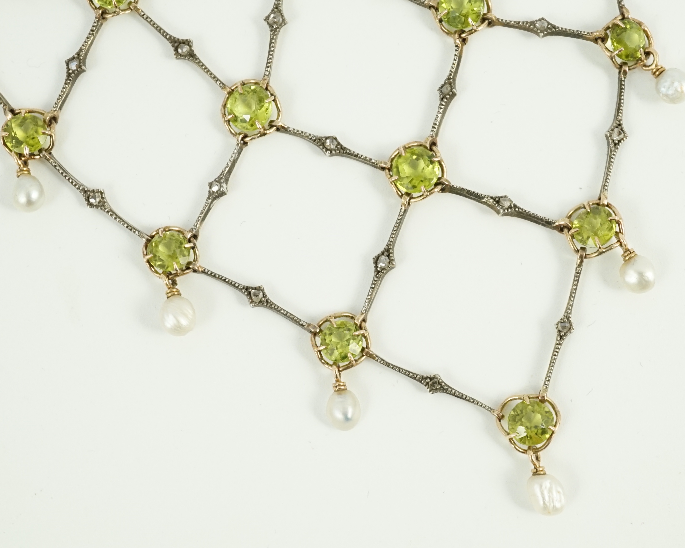 A late Victorian 15ct gold and platinum, peridot, rose cut diamond and baroque pearl drop set necklace